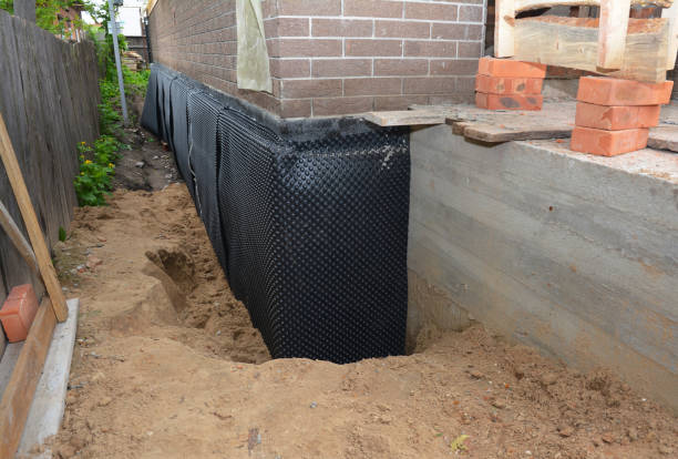 Happy homeowners after waterproofing job in Sanders
